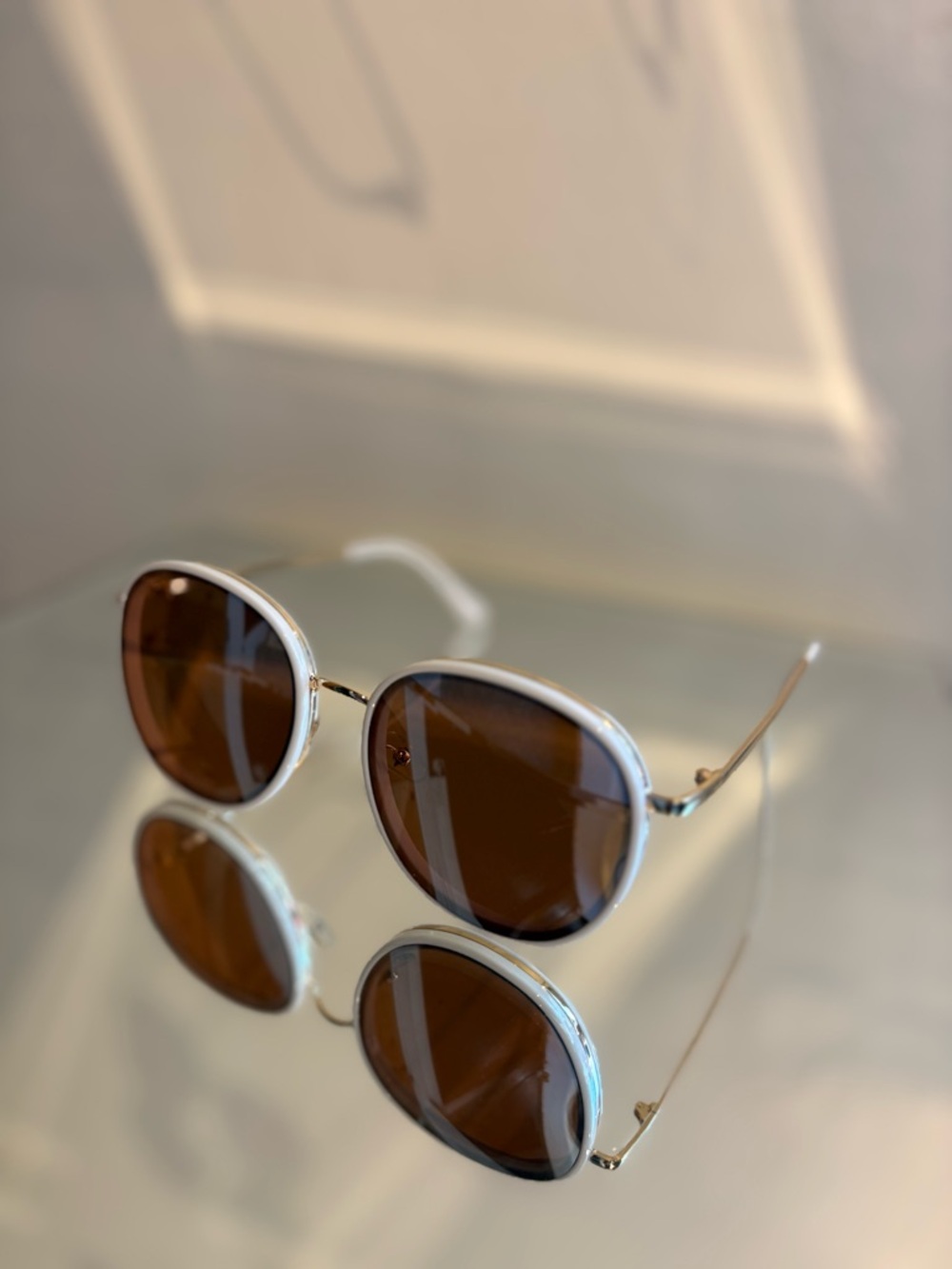 White mirrored Circle sunglasses.